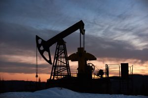 beautiful sunset over oil field with pump jack.